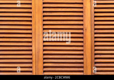 brown wooden shutters close up, shutters to protect the room from sunlight. Stock Photo