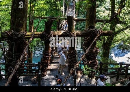 The Iya No Kazurabashi, a rather daunting tree vine suspension bridge over the Iya River.  This ancient vine bridge is suspended between a valley, sur Stock Photo