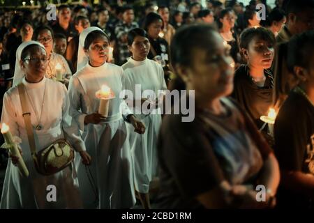 Larantuka, Indonesia. 3rd April, 2015. Roman-Catholic nuns are joining thousands of Catholic devotees and pilgrims participating in a four-hours devotional march to commemorate Good Friday, a part of Holy Week celebrations in Larantuka, East Flores, Flores Island, East Nusa Tenggara, Indonesia. Stock Photo