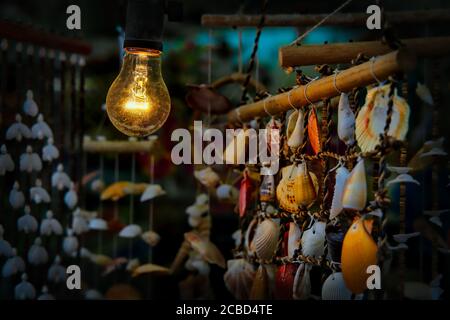 A light bulb shines on wind chimes in the port town of Jogashima, Japan, the southern most point on the Miura Peninsula. Stock Photo