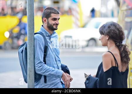 Young Georgian man and woman in a bus stop of Didube station, Tbilisi, Republic of Georgia Stock Photo