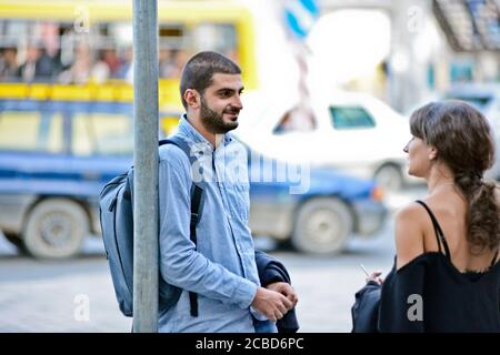 Young Georgian man and woman in a bus stop of Didube station, Tbilisi, Republic of Georgia Stock Photo