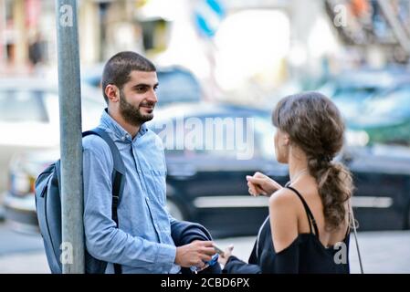 Young Georgian man and woman in a bus stop of Didube station, Tbilisi, Republic of Georgia Stock Photo