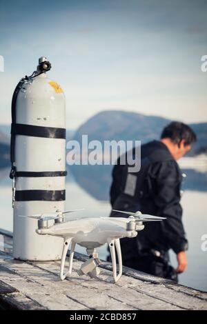 Drone Crash - Diver Standing Next to a Retrieved Drone Stock Photo