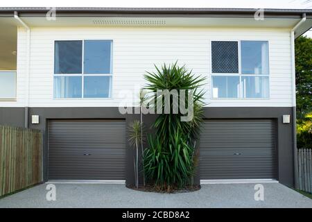 New contemporary style double storey house with double garage roller doors Stock Photo