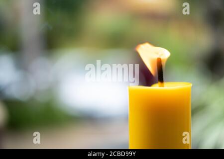 Light flame candle burning brightly on blurred background Stock Photo