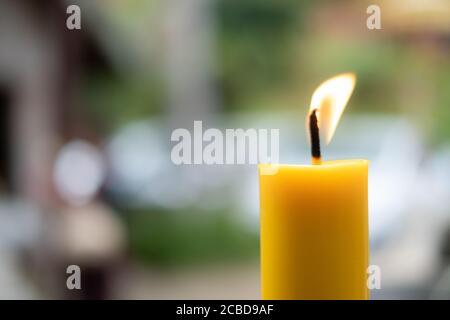 Light flame candle burning brightly on blurred background Stock Photo