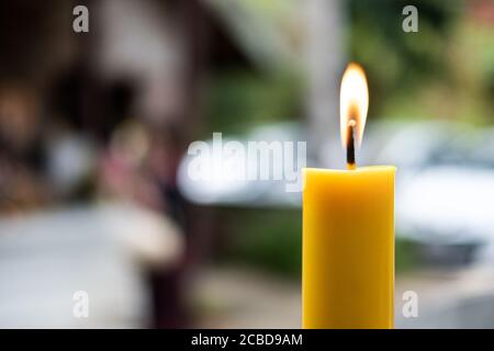 Light flame candle burning brightly on blurred background Stock Photo
