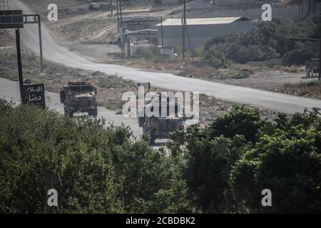 Idlib, Syria. 12th Aug, 2020. The Russian Military and the Turkish military conducted their 24th joint patrol on the M4 highway in the northwestern Syria region of Greater Idlib, on August 12, 2020. The joint patrol set off from the town of Tronba in southern Idlib and reached the town of Ain Hawr in northern Lattakia, completing its entire route. No incidents whatsoever were reported during the patrol. (Photo by Azalden Idlib/INA Photo Agency/Sipa USA) Credit: Sipa USA/Alamy Live News Stock Photo