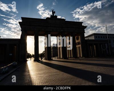 Berlin, Germany. 13th Aug, 2020. The Brandenburg Gate casts shadows in the light of the rising sun. Today 59 years ago, on 13 August 1961, the construction of the Wall began. This also blocked the passage through the gate. Credit: Paul Zinken/dpa/Alamy Live News Stock Photo