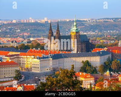 Prague Castle complex with gothic St Vitus Cathedral in the evening time illuminated by sunset, Hradcany, Prague, Czech Republic. UNESCO World Heritage. Aerial shot from Petrin Tower. Stock Photo