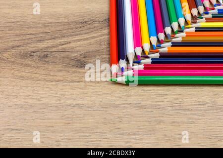 colored pencils aligned vertically and horizontally with crossed tips on the table Stock Photo