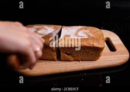 Homemade gray bread on a black background. Photo in section. Stock Photo