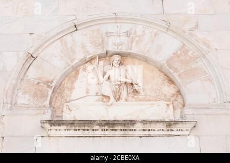 Bas-relief depicting the resurrection of Jesus on the facade of the cathedral of Pietrasanta. Stock Photo