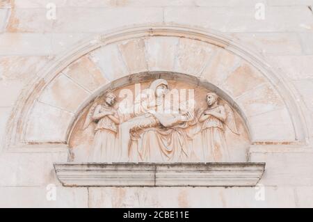 Bas-relief depicting the deposition of Jesus on the facade of the cathedral of Pietrasanta. Stock Photo