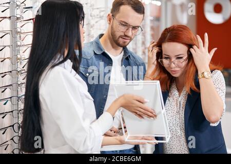 bearded guy wants to buy new glasses for his girlfriend as a gift. close up photo, fashion,people