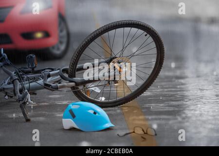 Accident car crash with bicycle on road ,rainy day. Stock Photo