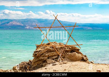 Wooden Shield of David (Magen David or Star of David) with the Dead Sea in the background