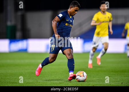 Brazilian football player Renato Ribeiro Calixto or Renatinho of Guangzhou R&F F.C. keeps the ball during the fourth-round match of 2020 Chinese Super League (CSL) against Jiangsu Suning F.C., Dalian city, northeast China's Liaoning province, 9 August 2020. Guangzhou R&F F.C. was defeated by Jiangsu Suning F.C. with 0-2. Stock Photo