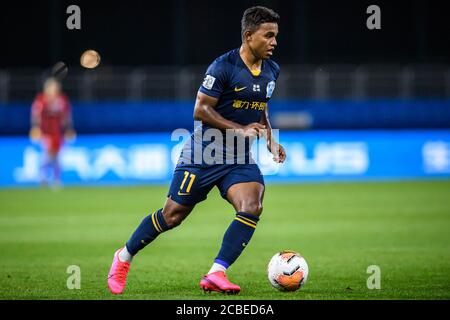 Brazilian football player Renato Ribeiro Calixto or Renatinho of Guangzhou R&F F.C. keeps the ball during the fourth-round match of 2020 Chinese Super League (CSL) against Jiangsu Suning F.C., Dalian city, northeast China's Liaoning province, 9 August 2020. Guangzhou R&F F.C. was defeated by Jiangsu Suning F.C. with 0-2. Stock Photo