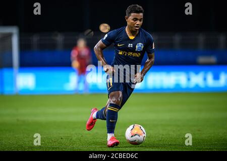 Brazilian football player Renato Ribeiro Calixto or Renatinho of Guangzhou R&F F.C. keeps the ball during the fourth-round match of 2020 Chinese Super League (CSL) against Jiangsu Suning F.C., Dalian city, northeast China's Liaoning province, 9 August 2020. Guangzhou R&F F.C. was defeated by Jiangsu Suning F.C. with 0-2. Stock Photo