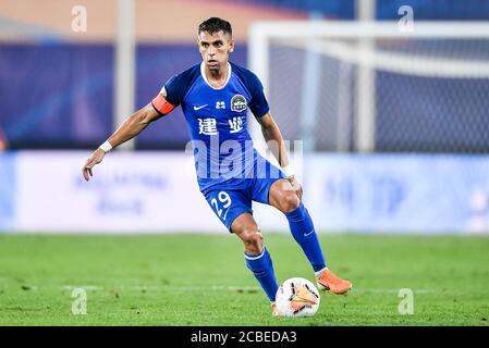 Brazilian football player Olivio da Rosa, also known as Ivo, of Henan Jianye F.C. keeps the ball during the fourth-round match of 2020 Chinese Super League (CSL) against Shenzhen F.C., Dalian city, northeast China's Liaoning province, 10 August 2020. Shenzhen F.C. was defeated by Henan Jianye F.C. with 1-2.