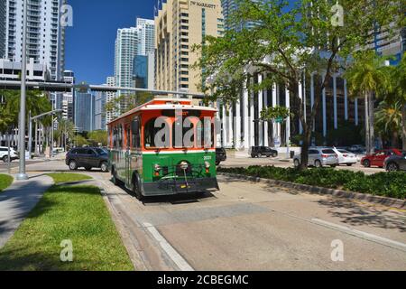MIAMI BEACH, USA - MARCH 19, 2017 : Green trolley goes on Downtown Miami street. Miami Trolley provides free transportation in the city Stock Photo