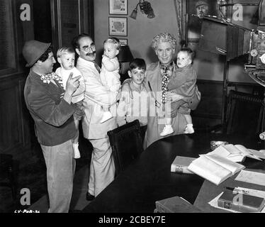 CHICO MARX GROUCHO MARX and HARPO MARX on set candid with Harpo's 4 adopted children MINNIE, JIMMIE, BILLY WOOLLCOTT and ALEXANDER during filming of A NIGHT IN CASABLANCA 1946 director ARCHIE L. MAYO producer David L. Loew Loma Vista Productions / United Artists Stock Photo