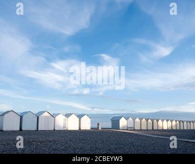 beach huts in cayeux s mer in french normandy under blue sky Stock Photo