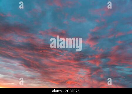 Clouds are colored in different shades at sunset Stock Photo
