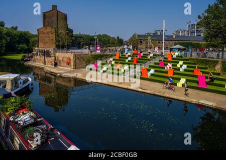 Granary Square Kings Cross London - Coal Drops Yard - summer seating at the side of the Regents Canal. Stock Photo