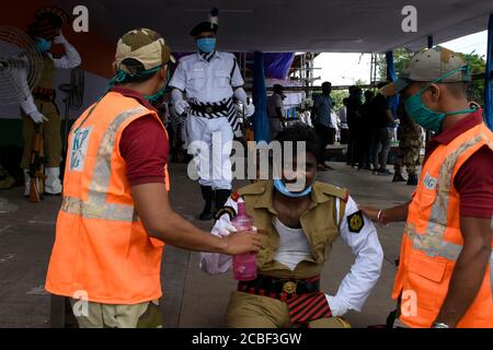 Kolkata, India. 13th Aug, 2020. A member of Kolkata Armed Police suddenly feeling uneasy and taking rest. (Photo by Suraranjan Nandi/Pacific Press) Credit: Pacific Press Media Production Corp./Alamy Live News Stock Photo