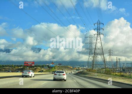 LOS ANGELES, CA, USA - MARCH 17, 2018 : Traffic on the Interstate 605, exit road from Los Angeles. High voltage electric poles. Stock Photo