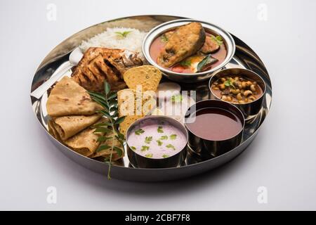 Indian Fish Platter or thali - Popular sea food, Non vegetarian meal from Mumbai, Konkan, Maharashtra, Goa, Bengal, Kerala served in a steel plate or Stock Photo