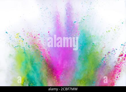 Multi colored powder explosion isolated on white background. Freeze motion of abstract dust texture. Stock Photo