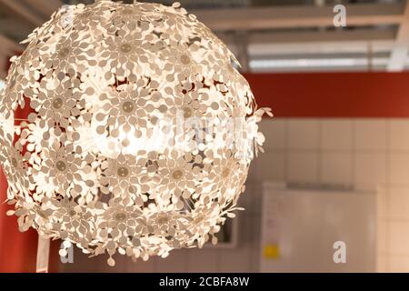 White lamps - chandeliers in the shape of a ball of daisies on the blurred background.white lightning ball. modern art luxury chandelier.ighting ball Stock Photo