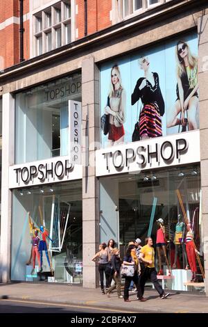 London, United Kingdom, Apr 17, 2011 : Topshop clothing store in Kensington High Street showing a ladies fashion clothes on display in its shop window Stock Photo