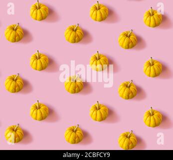 Seamless pattern with pumpkins on a pastel pink background Stock Photo