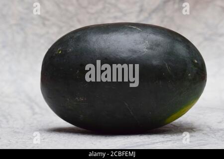 Watermelon fruit from Asia India. Fresh Indian fruit water melon also known as Tarbuz in India, Pakistan, Nepal isolated single piece on white backgro Stock Photo