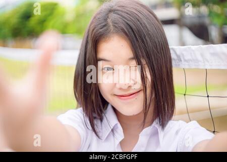 Cute asian student girl winking eye smiling expression selfie camera, close-up shot Stock Photo