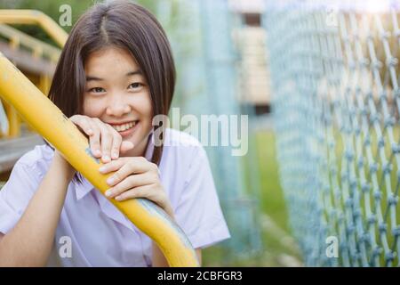 Asian student girl teen innocent shy smiling and looking camera with copy space Stock Photo