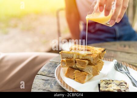 Toast bread topped with sweetened condensed milk unhealthy fat food Stock Photo