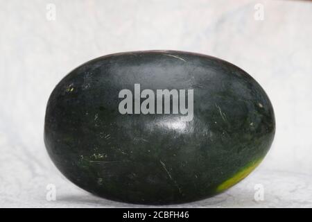 Watermelon fruit from Asia India. Fresh Indian fruit water melon also known as Tarbuz in India, Pakistan, Nepal isolated single piece on white backgro Stock Photo