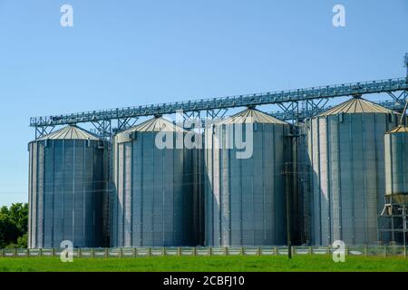 Agricultural Silos. Storage and drying of grains, wheat, corn. Harvesting. Stock Photo