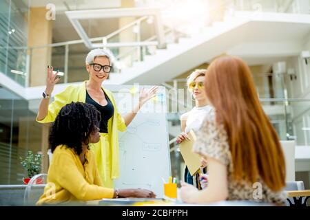 I have a great idea. excited blond woman with raised arms talking something.successful plan. happy women have solved business problem Stock Photo