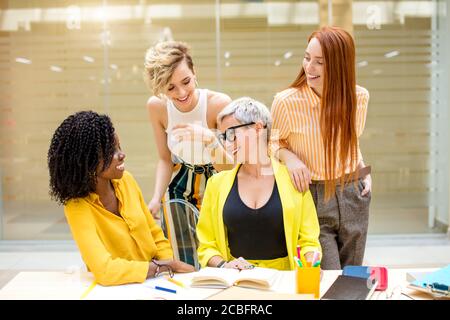 friendly awesome women making compliments to their boss. close up photo. cheerful businesswomen say nice things to each other Stock Photo