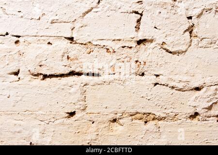 The texture of the old brick wall painted with white paint. Stock Photo