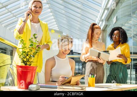 working atmosphere in a small company.awesome friendly businesswomen developing a plan Stock Photo