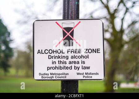 Alcohol Free Zone sign isolated outdoors on lamp post in UK park. Public notice: no drinking alcohol, prohibited. Stock Photo
