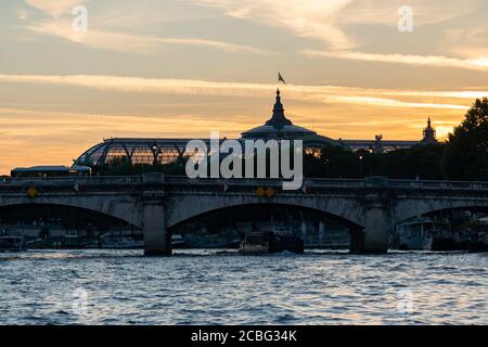 View from seine river to the Pont de la Concorde and the Grand Palais of Paris after sunset. Excursion with boats called bateaux-mouches on the seine Stock Photo